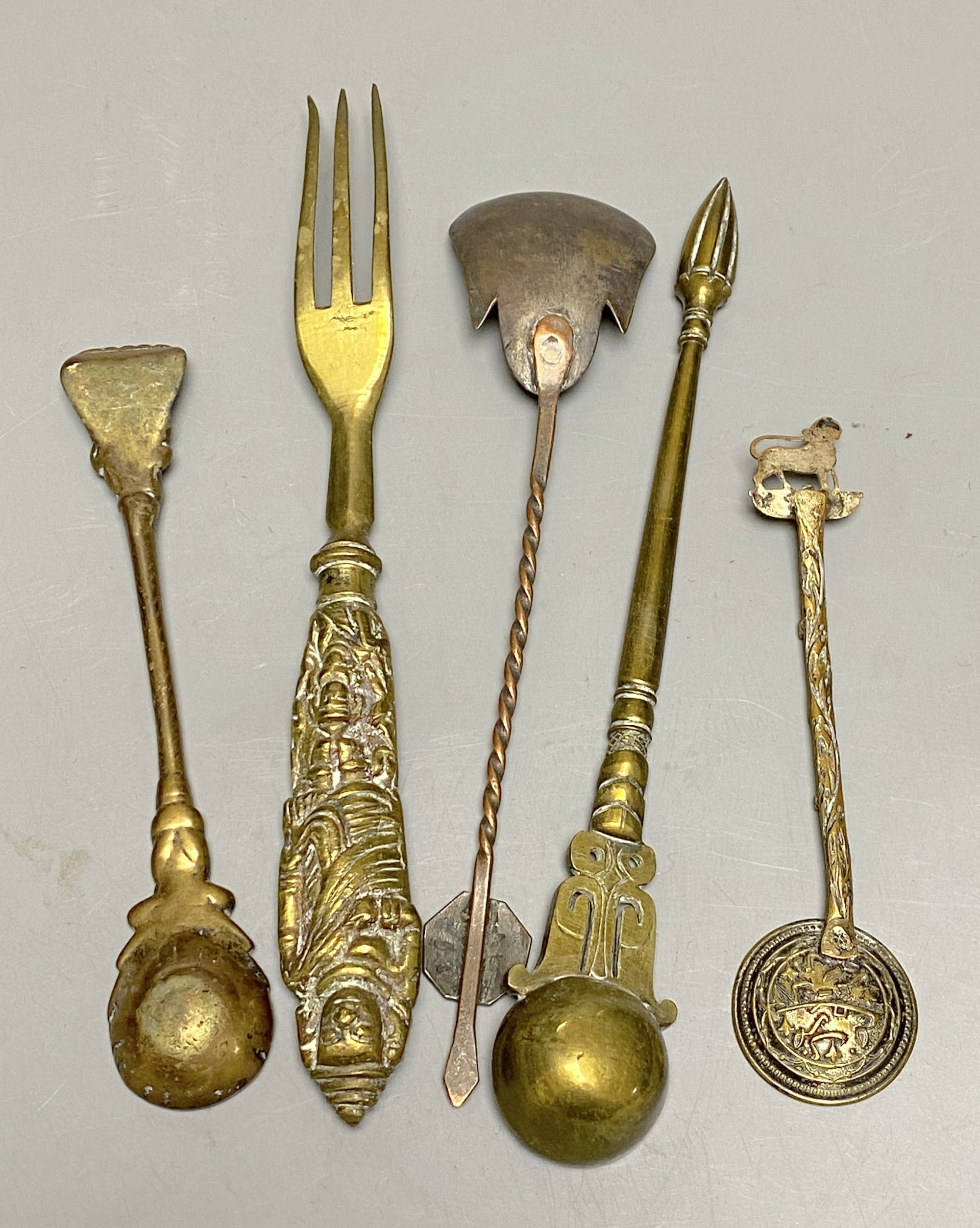 A group of Indian bronze spoons and a fork